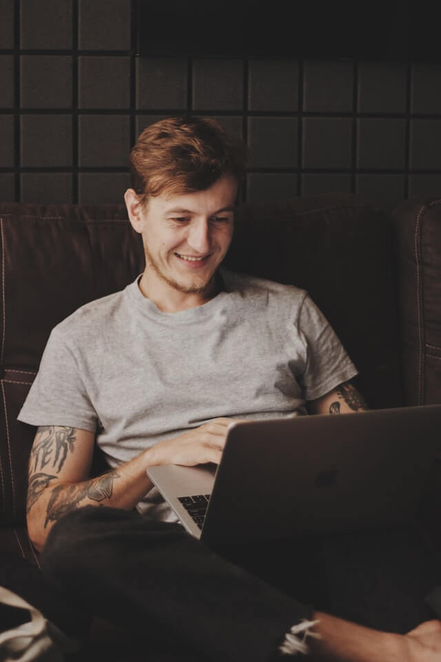 a person looking at their laptop smiling